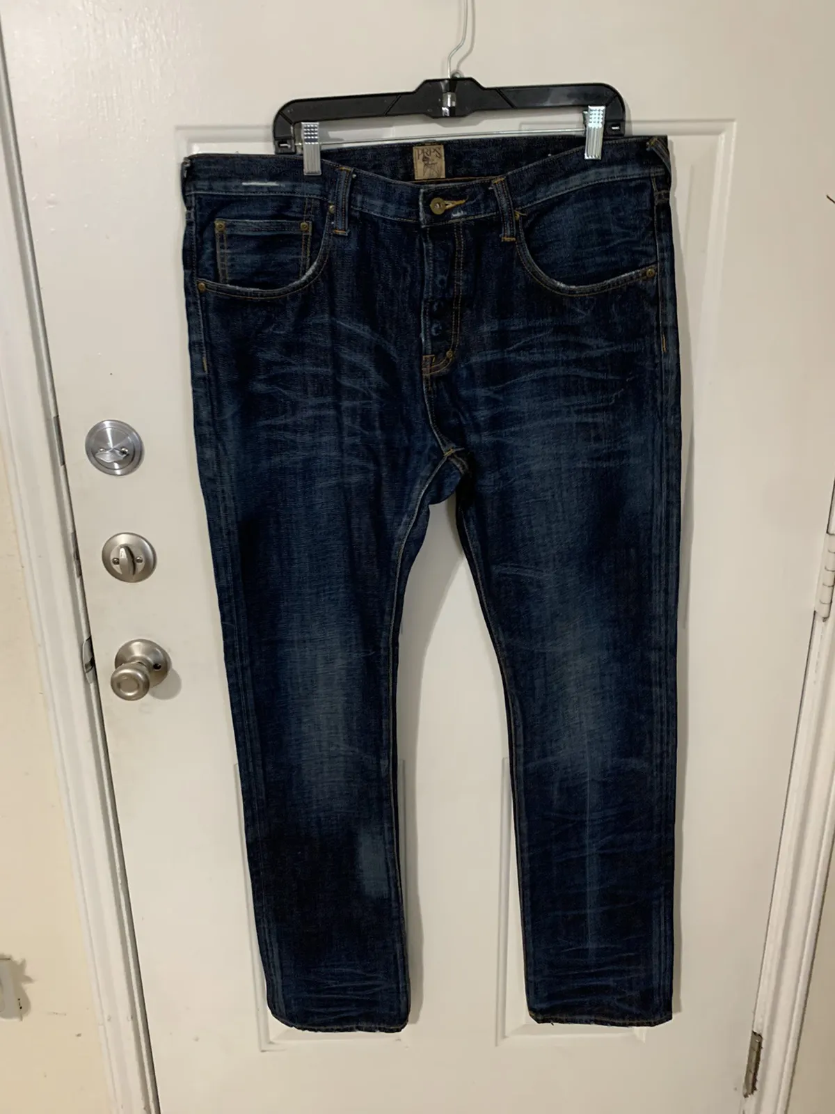 Demon Button fly distressed denim jeans